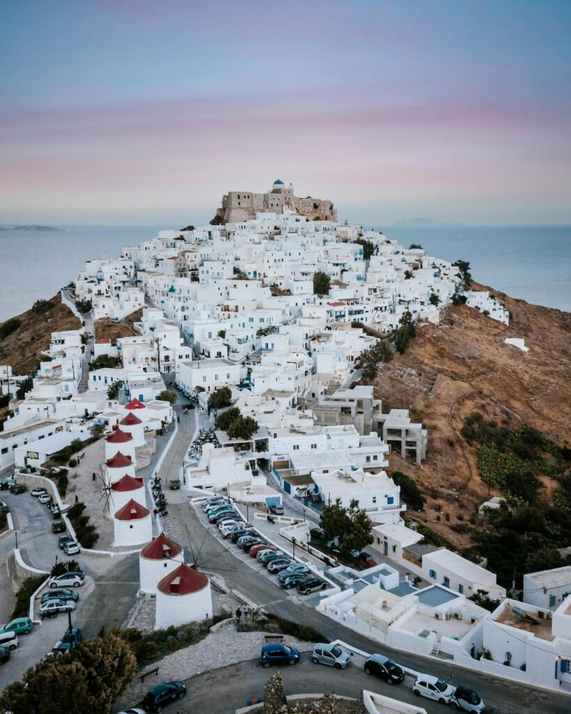pexels-photo-10547411-10547411 A stunning aerial shot of Astypalaia's white-washed buildings against a twilight sky, ideal for travel enthusiasts.