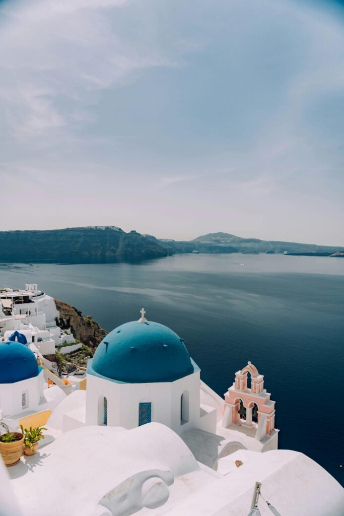 pexels-photo-17034836-17034836 Greece's Santorini with blue domes and sea, perfect summer getaway.
